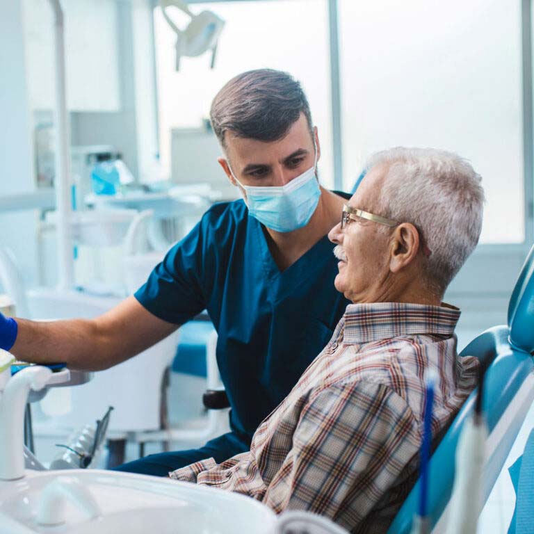 Doctor Performing Oral Surgery On An Elder Patient In Greater Oklahoma City 