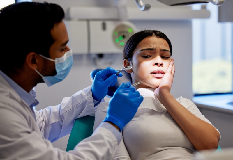 Dentist treating traumatic dental injury of a woman in Greater Oklahoma City