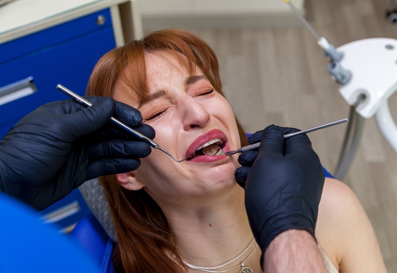 A girl in pain beacuse of her traumatic dental injury in Greater Oklahoma City